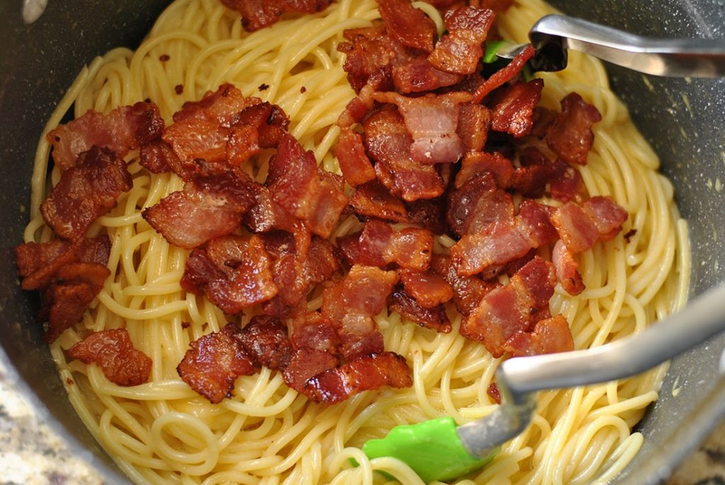Bacon added to cooked spaghetti
