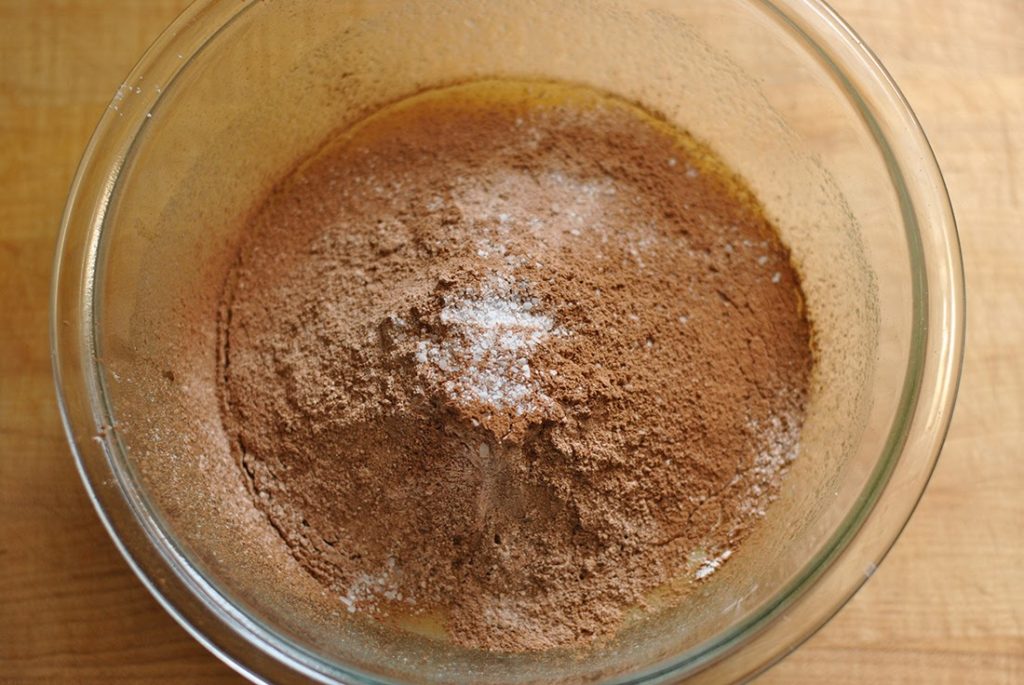 Add dry ingredients to wet ingredients for chocolate fudge brownies