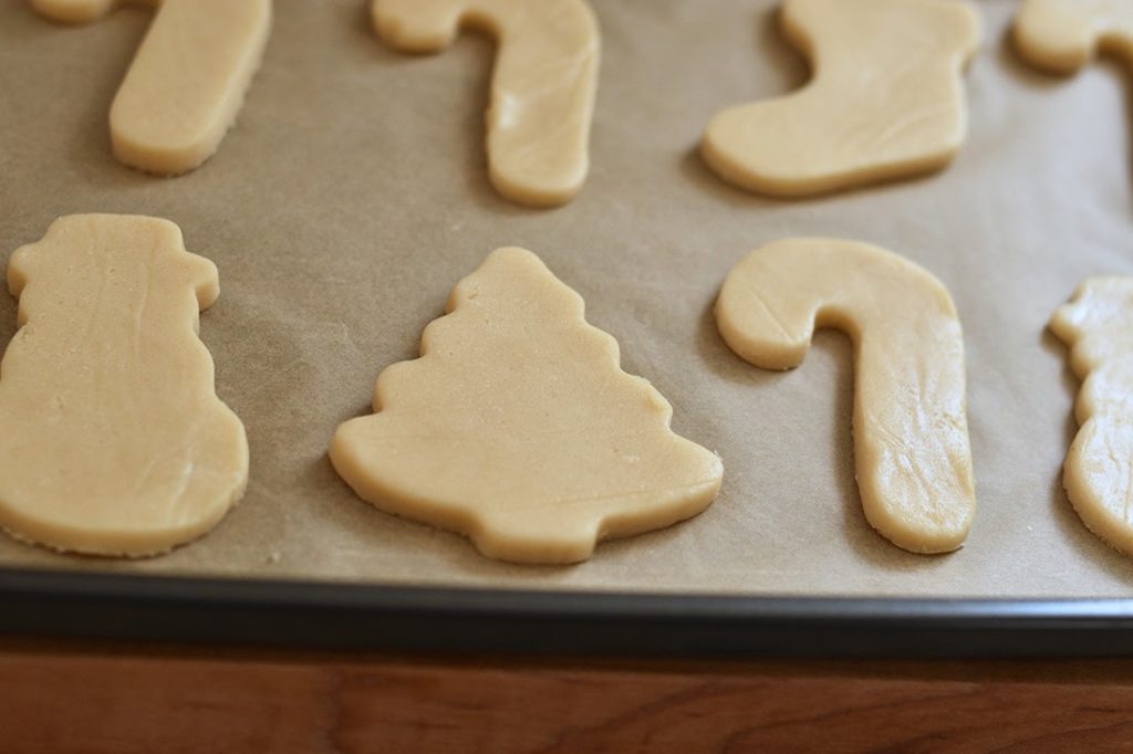 Xmas cookies cut in shapes on a baking tray