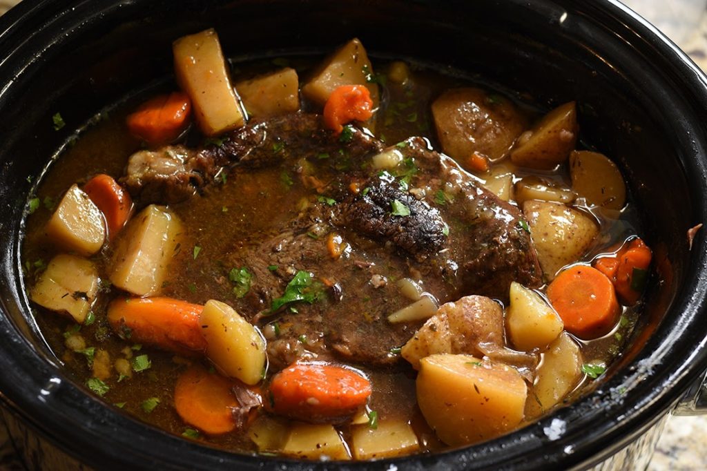 Adding Garnish to the Pot Roast in the Slow Cooker