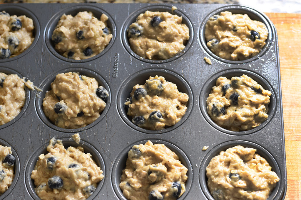 Blueberry muffin batter in muffin tin