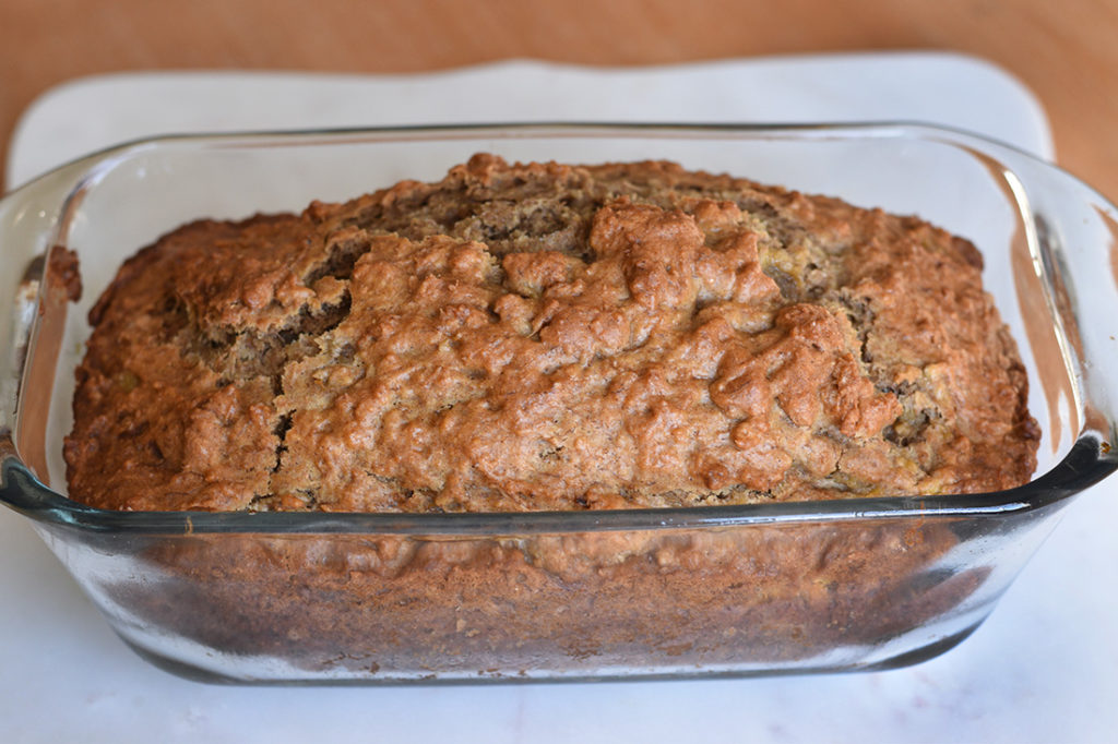 Just baked banana bread in a loaf pan ready to serve