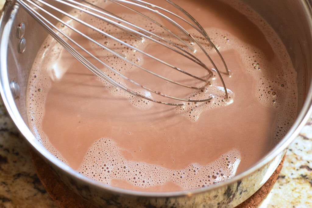Cocoa powder added in pan of cream and almond milk