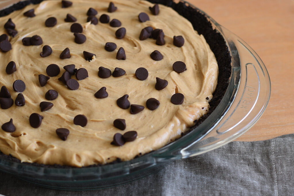 Whole no bake chocolate peanut butter pie with chocolate chips toppings