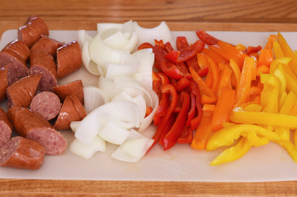 Sliced ingredients of baked sausage and peppers recipe