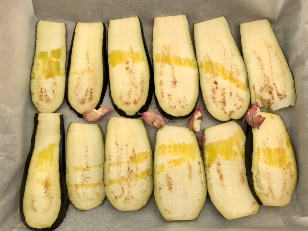 Sliced eggplants in a baking sheet