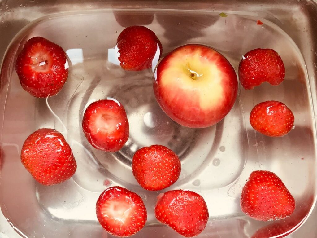 Strawberries and apple soaked in water